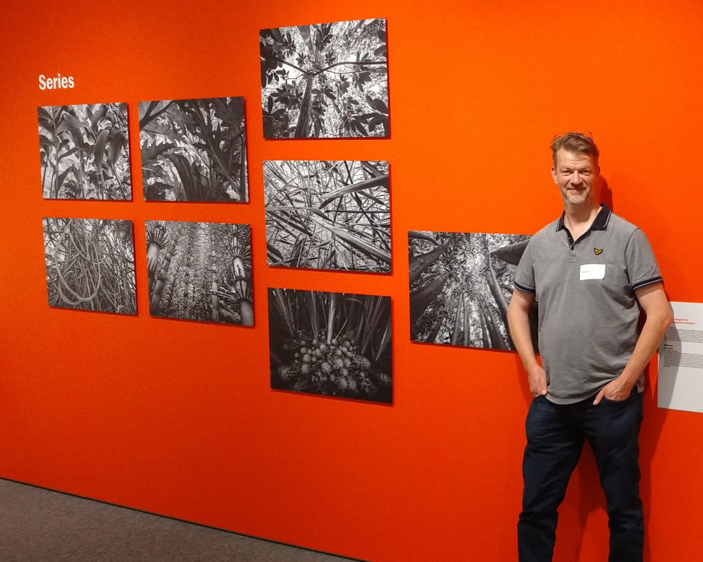 Photographer Jowan Iven standing in front of his winning series at De Groene Camera 2022 photo contest